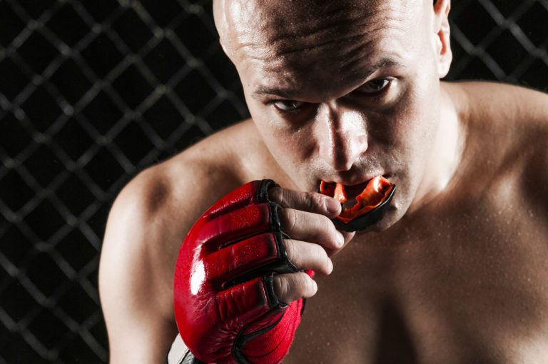 Man wearing rubber sports mouth guard