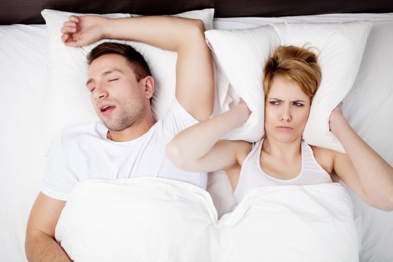 Sleep Apnea & Snoring - angry woman in bed with snoring man